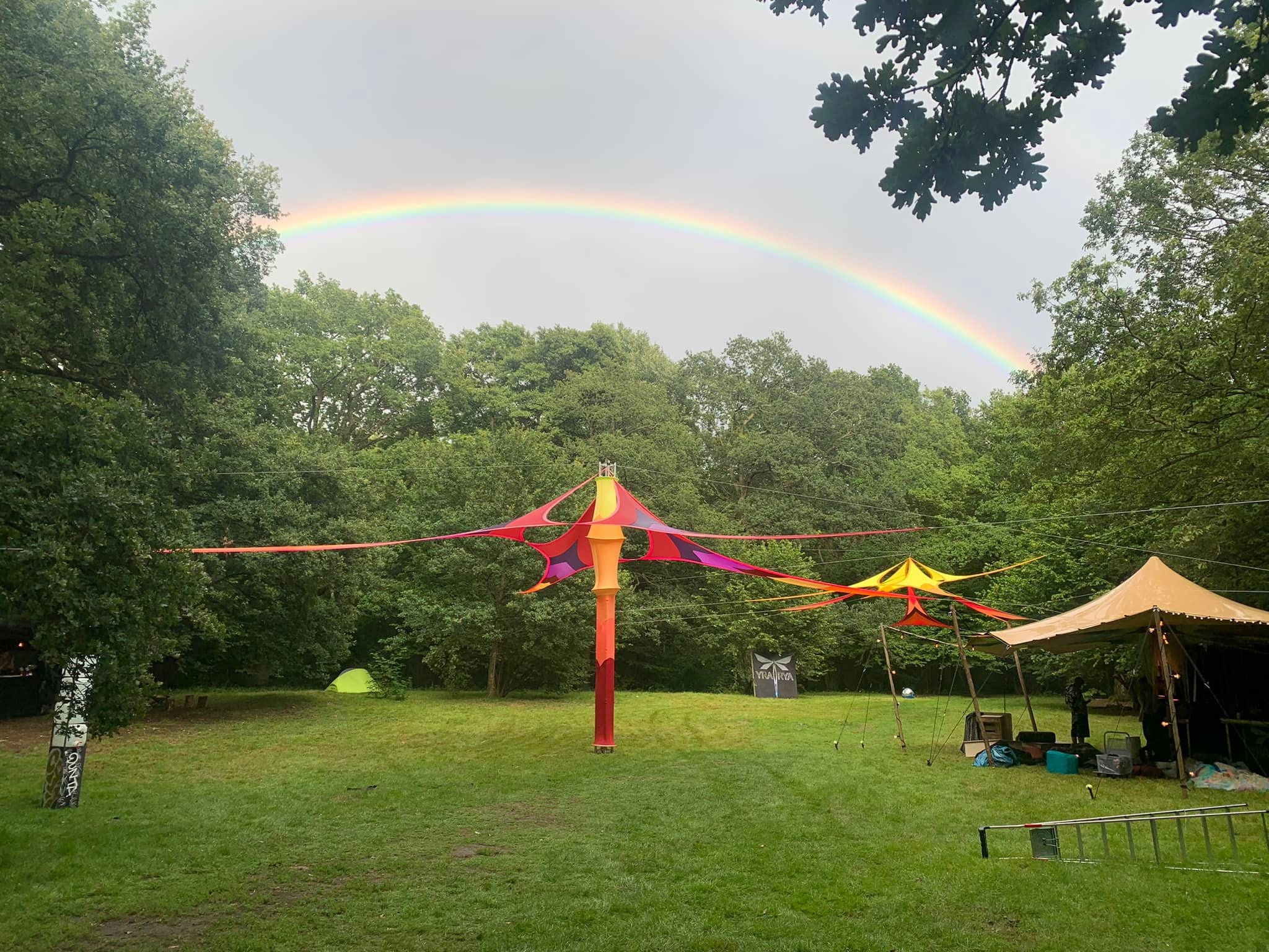 Rainbow arcing over a Cirkus Paralello open air site